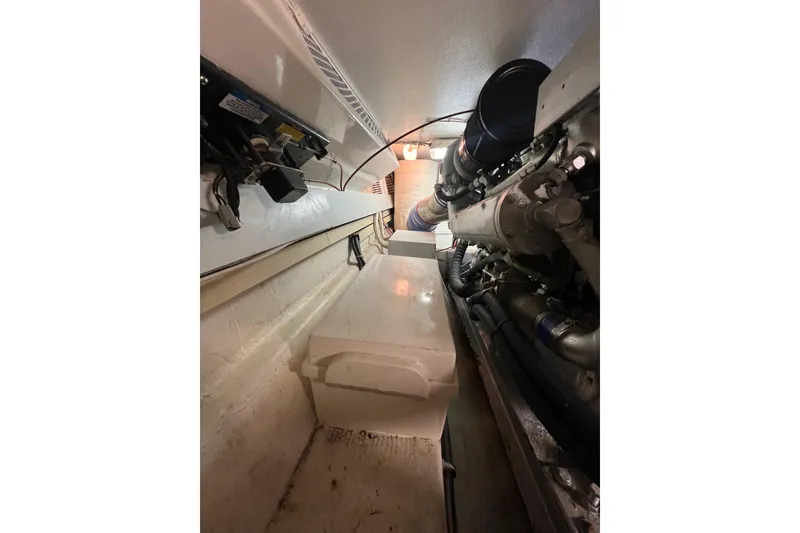Slide: The Image of Engine room of a 1991 Viking Convertible boat, showcasing mechanical components. - 73