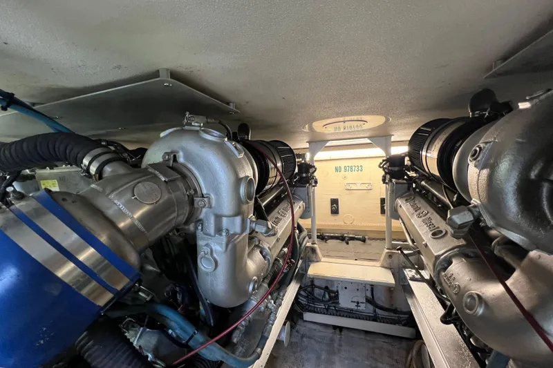 Slide: The Image of Engine room of a 1991 Viking Convertible boat, showcasing dual engines and mechanical components. - 74