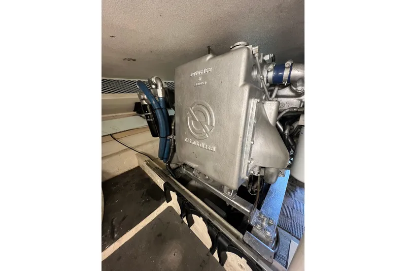 Slide: The Image of Engine compartment of a 1991 Viking Convertible boat, featuring a diesel engine. - 77