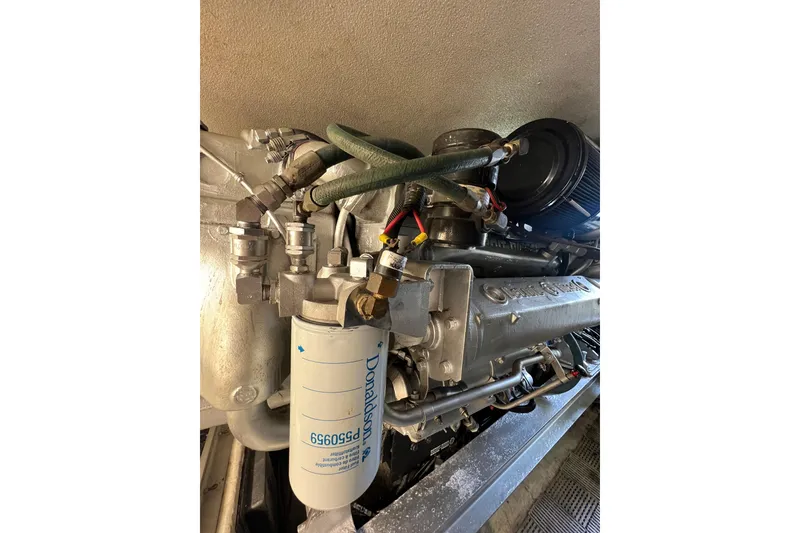 Slide: The Image of Engine compartment of a 1991 Viking Convertible boat, featuring a Donaldson filter. - 81