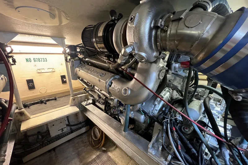 Slide: The Image of Engine room of a 1991 Viking Convertible boat, showcasing detailed machinery and components. - 91