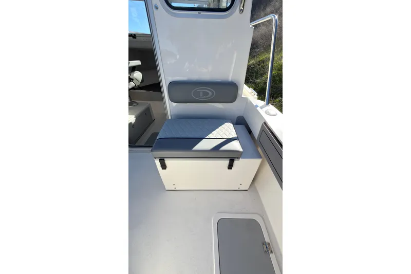 Slide: The Image of Interior seating of 2026 Defiance Admiral 220 EX boat, featuring cushioned bench and storage. - 11