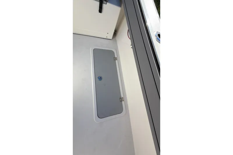 Slide: The Image of 2026 Defiance Admiral 220 EX boat interior with storage compartment. - 13