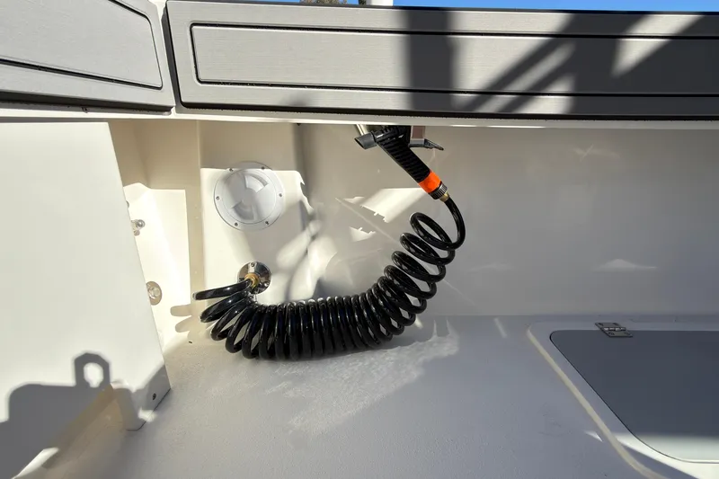 Slide: The Image of Coiled hose in Defiance Admiral 220 EX boat, 2026 model, interior detail. - 18