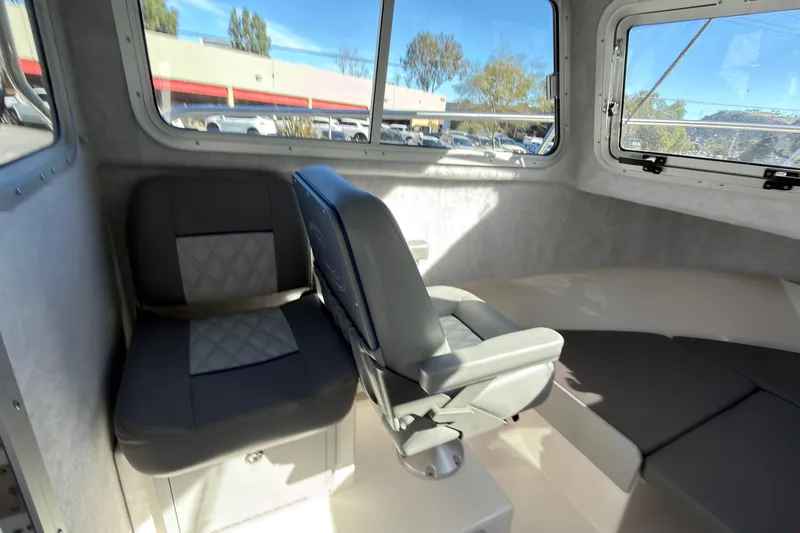 Slide: The Image of Interior of 2026 Defiance Admiral 220 EX boat with seating and windows. - 22