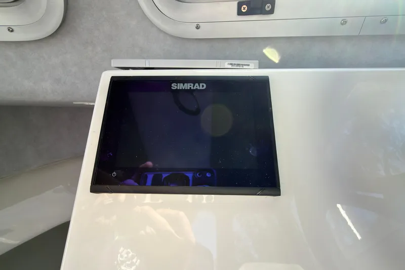 Slide: The Image of Simrad display on 2026 Defiance Admiral 220 EX boat dashboard. - 24