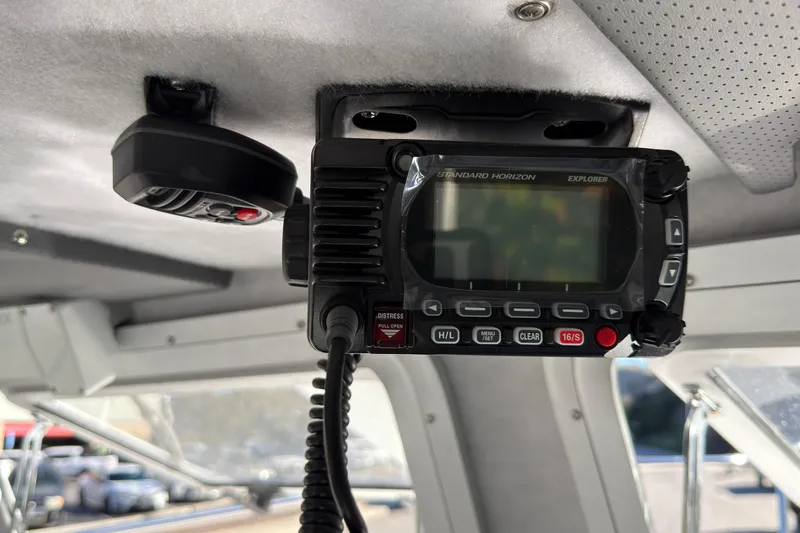 Slide: The Image of VHF radio installed in 2026 Defiance Admiral 220 EX boat interior. - 26