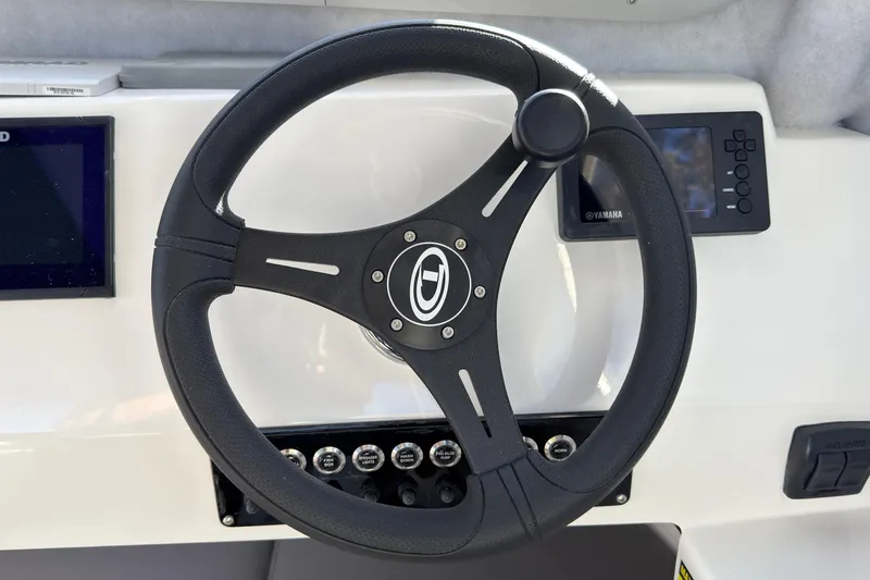 Slide: The Image of Steering wheel of 2026 Defiance Admiral 220 EX boat with control panel. - 29
