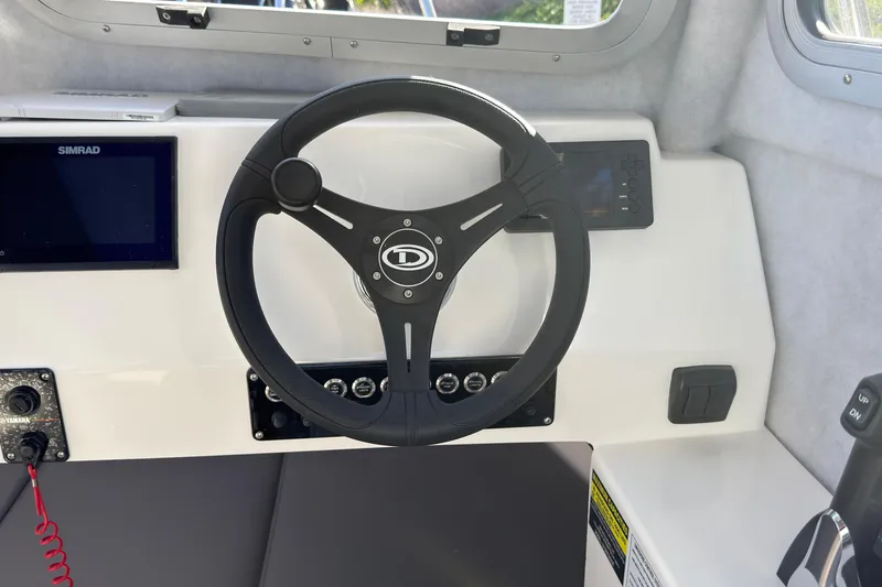 Slide: The Image of Steering wheel of 2026 Defiance Admiral 220 EX boat with control panel and display. - 30