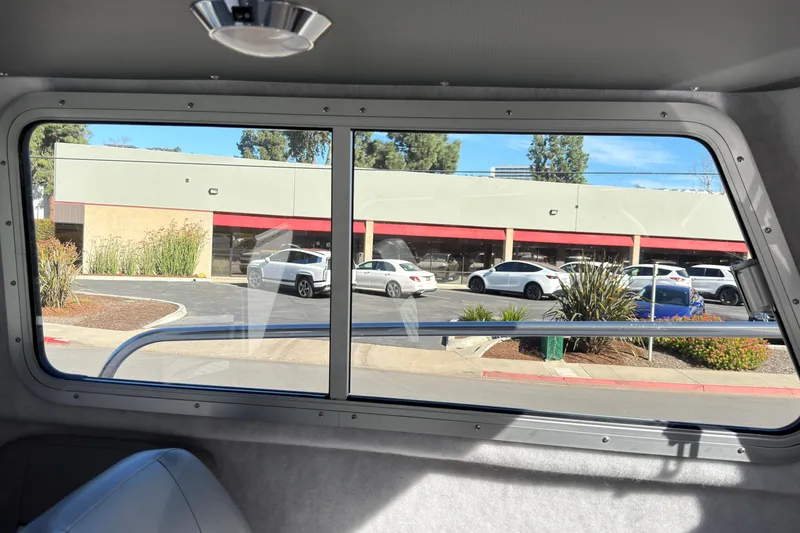 Slide: The Image of Interior view from 2026 Defiance Admiral 220 EX, showing parking lot and building outside. - 31