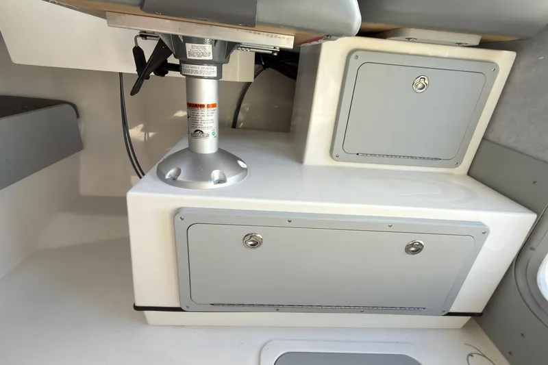 Slide: The Image of Interior of 2026 Defiance Admiral 220 EX boat with storage compartments and seating. - 34