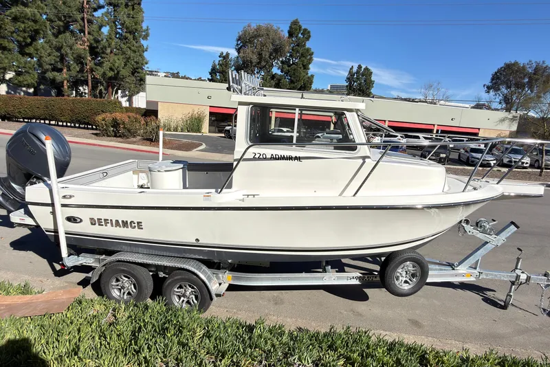 Slide: The Image of 2026 Defiance Admiral 220 EX boat on trailer, parked outdoors. - 37