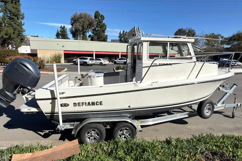 Slide: The Image of 2026 Defiance Admiral 220 EX boat on trailer, parked outdoors. - 38