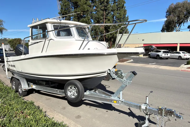 Slide: The Image of 2026 Defiance Admiral 220 EX boat on trailer, parked on street. - 5