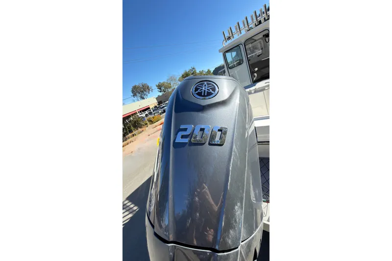 Slide: The Image of Outboard motor on 2026 Defiance Admiral 220 EX boat, sunny day, outdoor setting. - 7