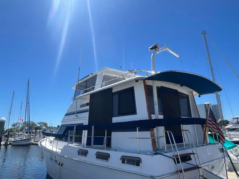 Slide: The Image of 1986 Gulfstar 44 Aft Cabin yacht docked under clear blue sky. - 1