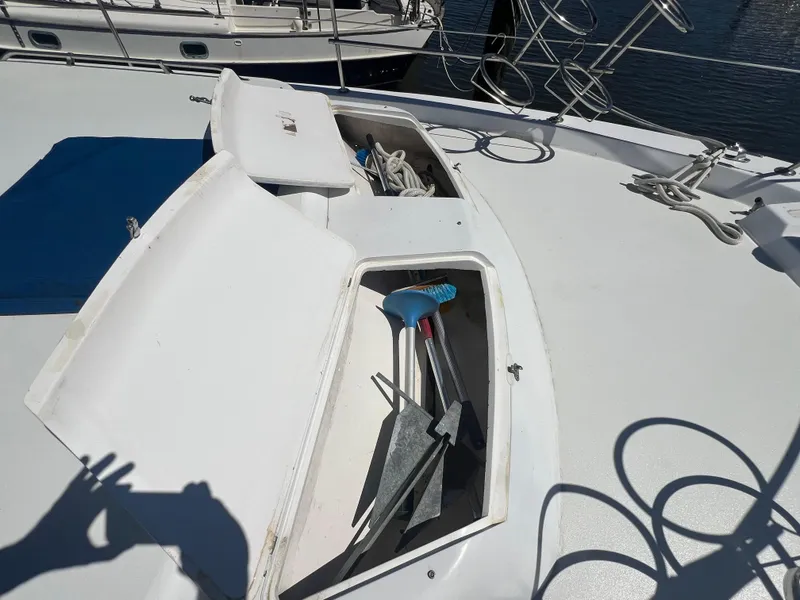 Slide: The Image of 1986 Gulfstar 44 Aft Cabin deck with open storage compartments and marine equipment. - 12