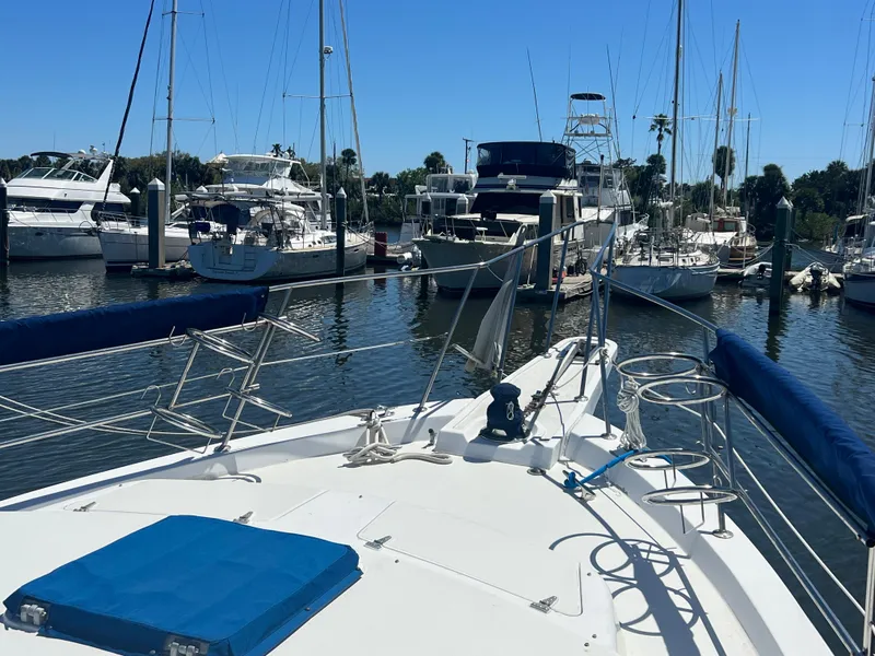 Slide: The Image of 1986 Gulfstar 44 Aft Cabin yacht docked in a marina with other boats. - 13