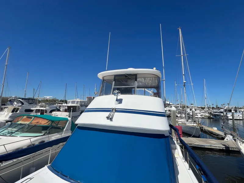 Slide: The Image of 1986 Gulfstar 44 Aft Cabin yacht docked in a marina under clear blue skies. - 15