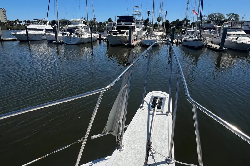 Slide: The Image of 1986 Gulfstar 44 Aft Cabin yacht docked in a marina with other boats. - 16