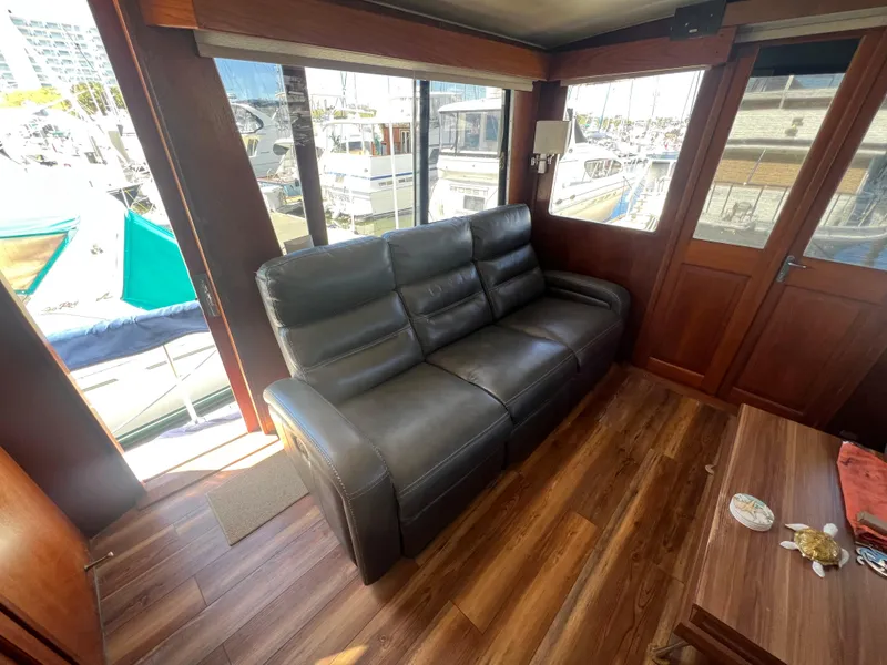 Slide: The Image of Luxurious interior of 1986 Gulfstar 44 Aft Cabin with leather sofa and wooden flooring. - 22
