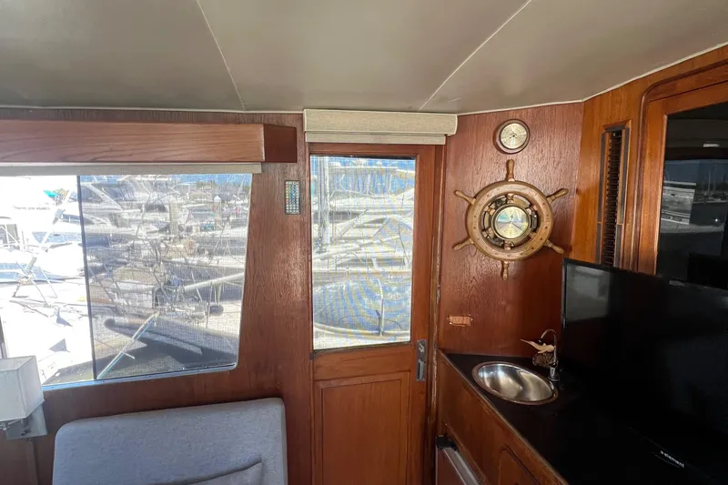 Slide: The Image of 1986 Gulfstar 44 Aft Cabin interior with nautical decor and marina view. - 23