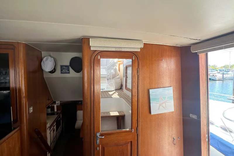 Slide: The Image of Interior of 1986 Gulfstar 44 Aft Cabin yacht with wooden paneling and nautical decor. - 27