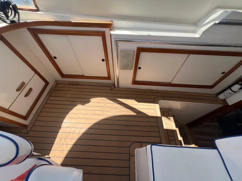 Slide: The Image of 1986 Gulfstar 44 Aft Cabin interior with wood flooring and white cabinetry. - 29