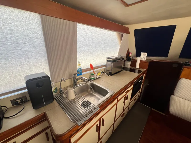 Slide: The Image of 1986 Gulfstar 44 Aft Cabin kitchen with sink, appliances, and ample counter space. - 45