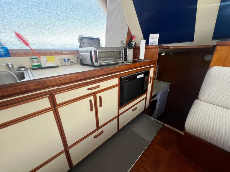 Slide: The Image of 1986 Gulfstar 44 Aft Cabin interior with kitchenette, featuring cabinets, sink, and appliances. - 47