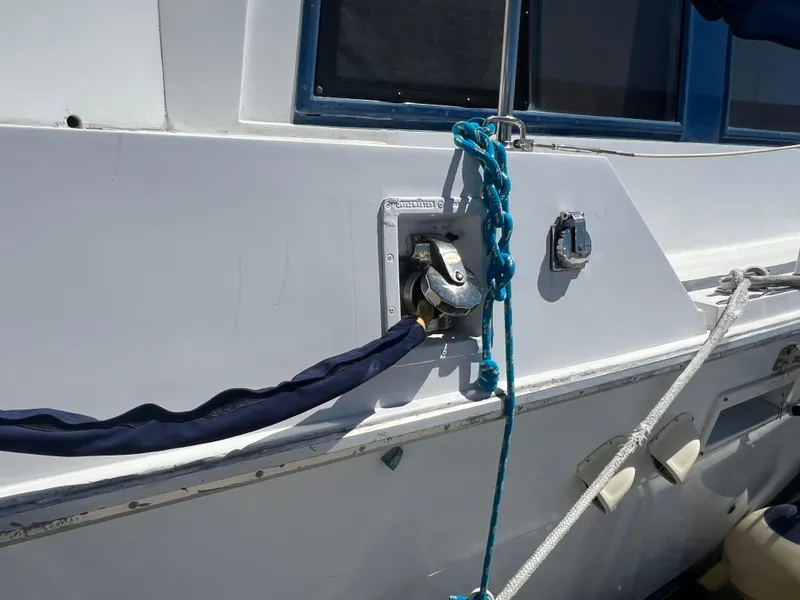Slide: The Image of 1986 Gulfstar 44 Aft Cabin boat with blue ropes and dock connection. - 6