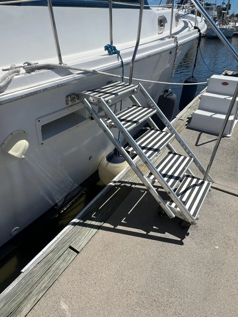 Slide: The Image of Stairs leading to a 1986 Gulfstar 44 Aft Cabin yacht docked at a marina. - 7
