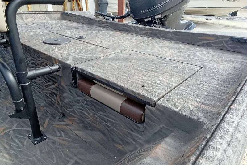 Slide: The Image of 2026 Alweld 2070 Vortex boat with camo pattern and storage compartment. - 9