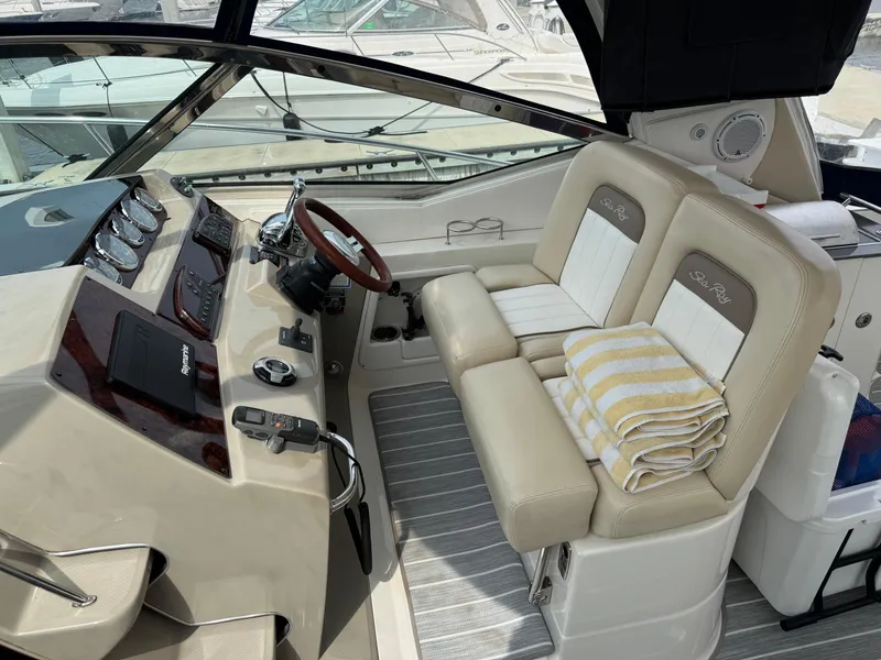 Slide: The Image of Helm of 2012 Sea Ray 370 Sundancer with dual seats and modern controls. - 17