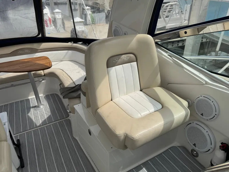 Slide: The Image of 2012 Sea Ray 370 Sundancer interior with beige seating and striped flooring. - 18