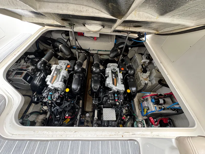 Slide: The Image of Engine compartment of a 2012 Sea Ray 370 Sundancer boat, showcasing dual engines. - 23
