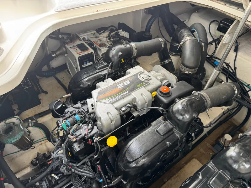 Slide: The Image of Engine compartment of a 2012 Sea Ray 370 Sundancer boat, showcasing detailed mechanical components. - 24