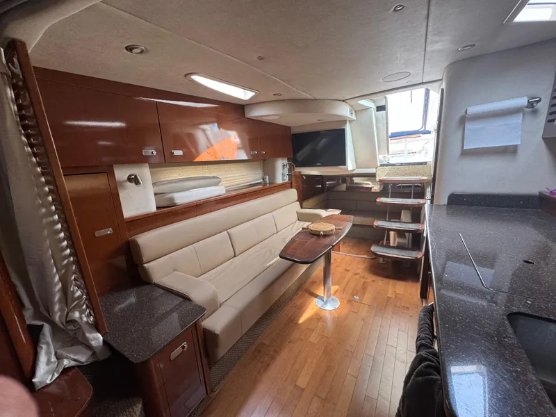 Slide: The Image of Luxurious interior of 2012 Sea Ray 370 Sundancer yacht with modern furnishings and wood flooring. - 8