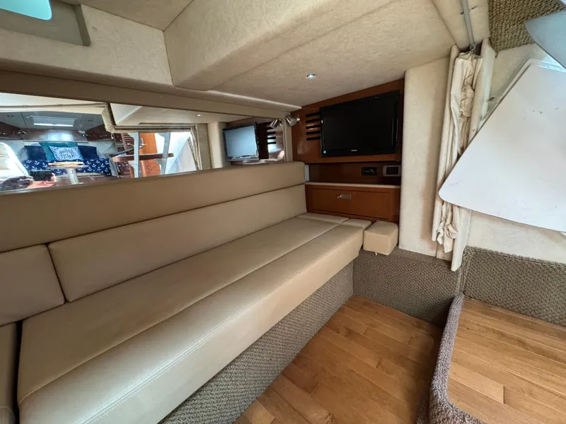 Slide: The Image of Interior of 2012 Sea Ray 370 Sundancer with beige seating and wooden flooring. - 9