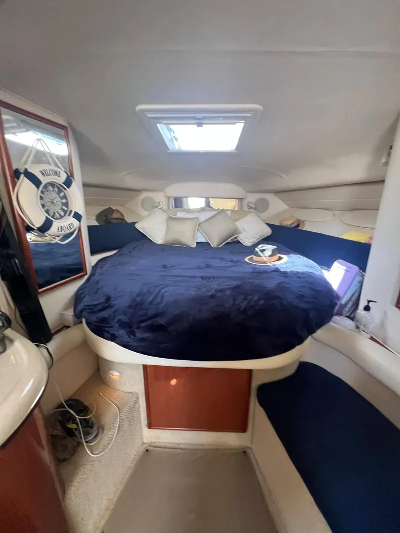 Slide: The Image of Interior of 2002 Sea Ray 340 Sundancer with cozy bed and nautical decor. - 14