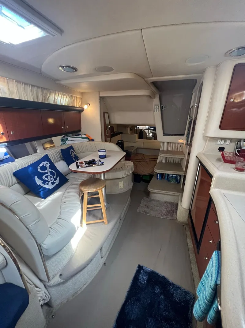Slide: The Image of Interior of 2002 Sea Ray 340 Sundancer yacht with cozy seating and nautical decor. - 20