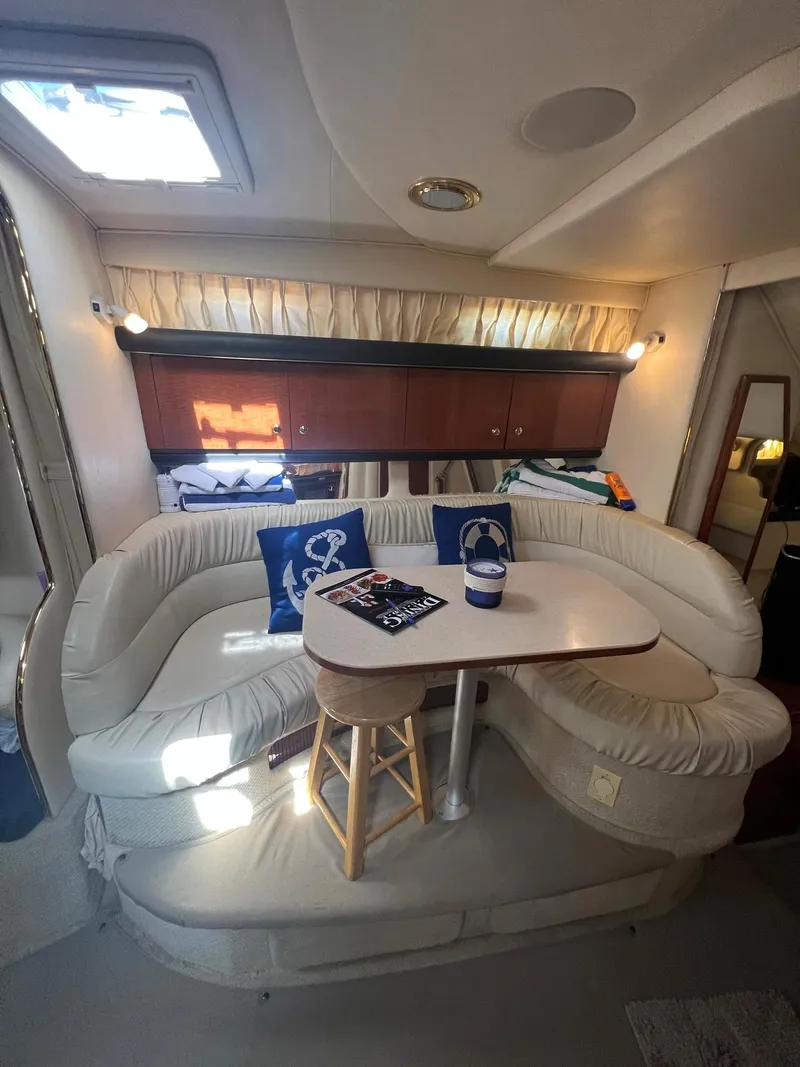 Slide: The Image of Interior of 2002 Sea Ray 340 Sundancer with cozy seating and nautical decor. - 21