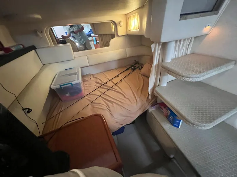 Slide: The Image of Interior of 2002 Sea Ray 340 Sundancer with fishing rods and storage box. - 24