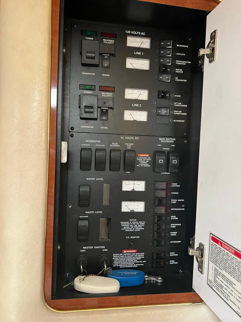 Slide: The Image of Electrical panel inside a 2002 Sea Ray 340 Sundancer boat, showing various switches and controls. - 25