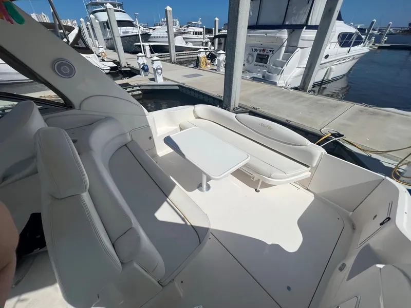 Slide: The Image of 2002 Sea Ray 340 Sundancer yacht interior with seating and table at marina. - 6