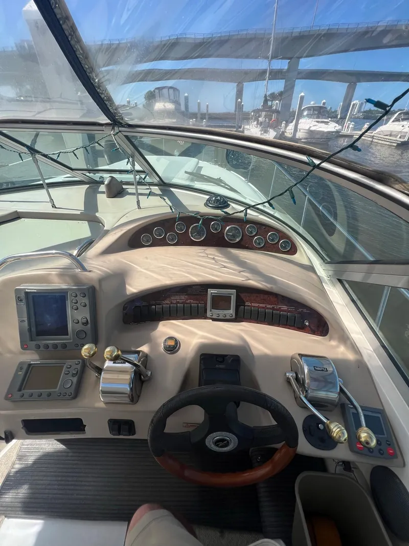Slide: The Image of 2002 Sea Ray 340 Sundancer helm with gauges, controls, and navigation equipment. - 9
