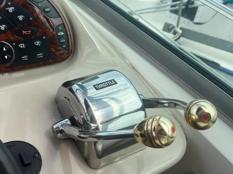 Slide: The Image of Throttle controls on a 2003 Sea Ray 320 Sundancer boat dashboard. - 17