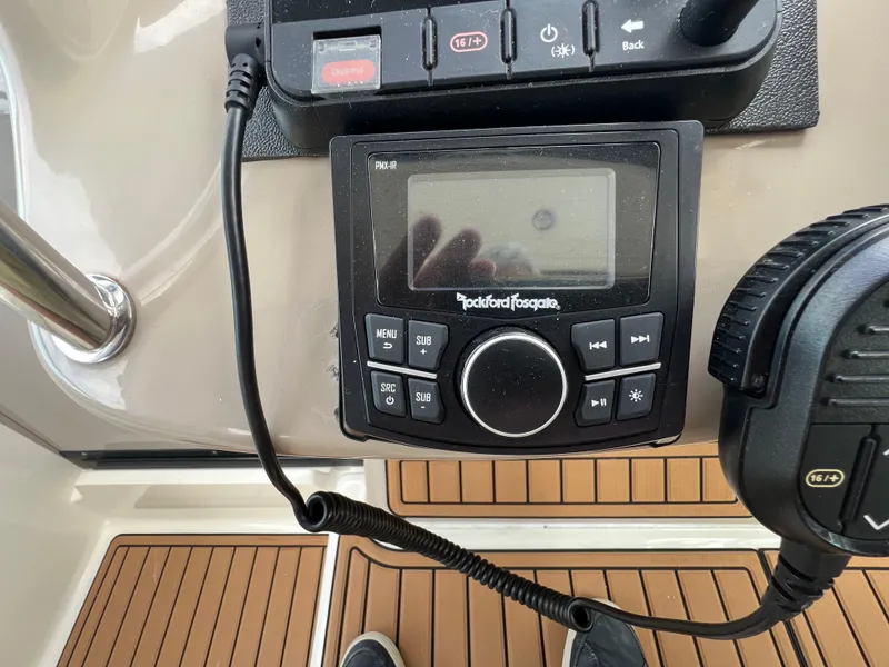 Slide: The Image of Control panel of a 2003 Sea Ray 320 Sundancer boat with Rockford Fosgate audio system. - 21