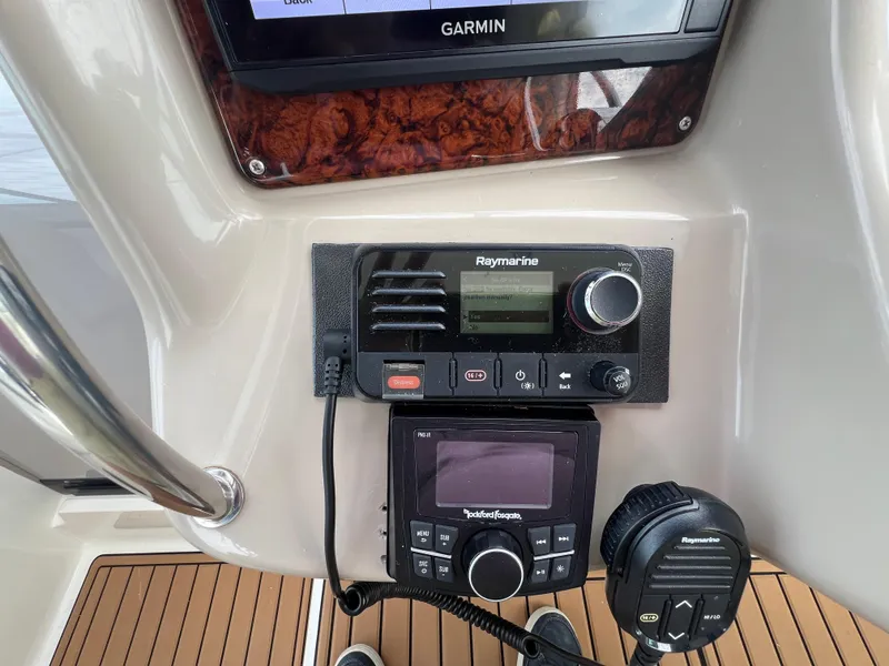 Slide: The Image of Control panel of a 2003 Sea Ray 320 Sundancer with Raymarine and Garmin equipment. - 22