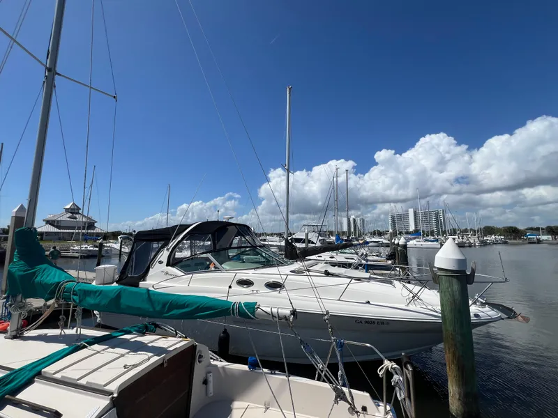 Slide: The Image of 2003 Sea Ray 320 Sundancer docked at a marina under a clear blue sky. - 3